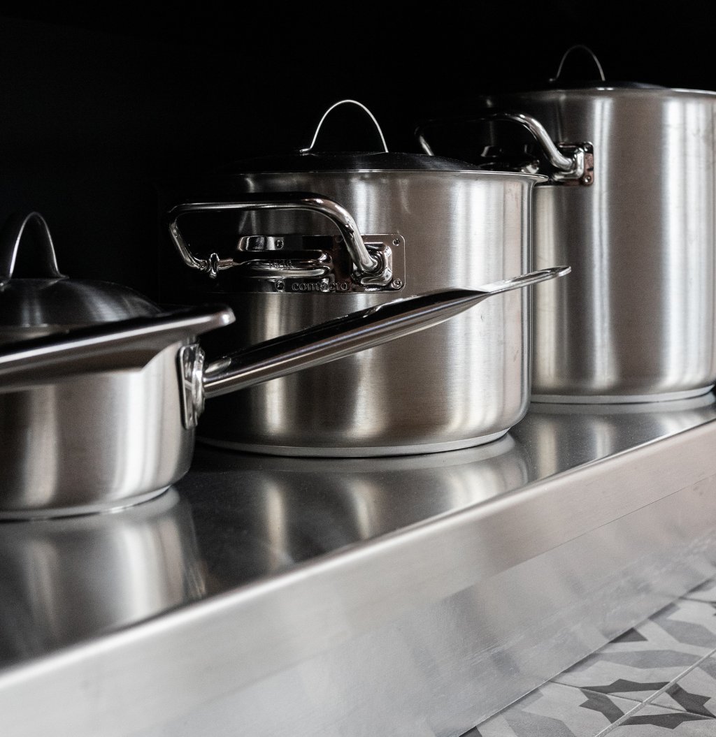Stainless steel pots & pans. Photo by Justus Menke on Unsplash.