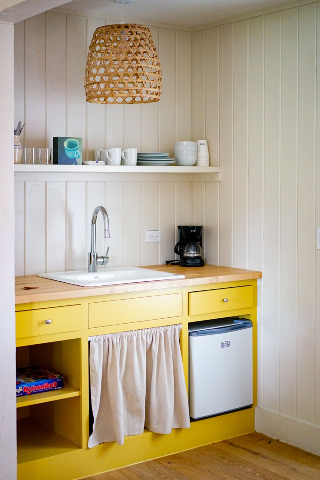 Kitchen sink with yellow countertops.