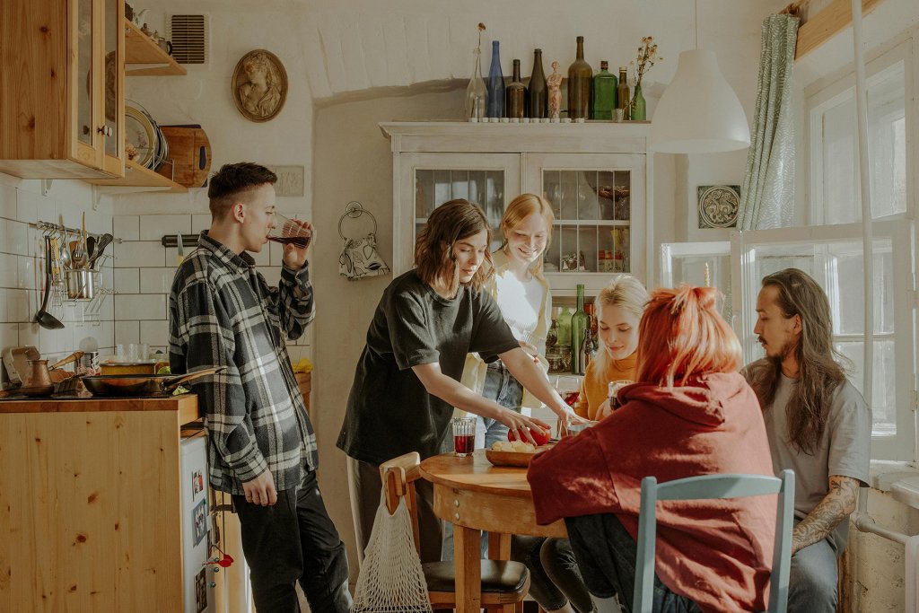 Visiting friends in a kitchen by CottonBro Studio on Pexels.